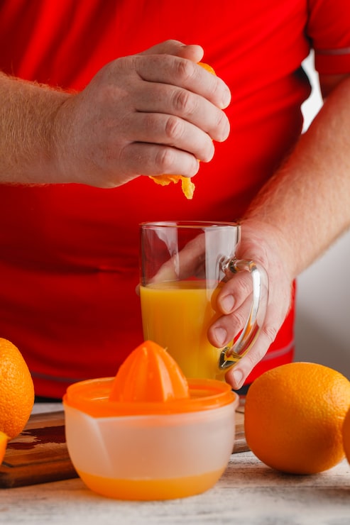 Man making orange juice | Holistic Menus