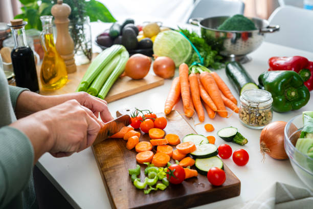 Person chopping fresh colorful vegetables | Holistic Menus