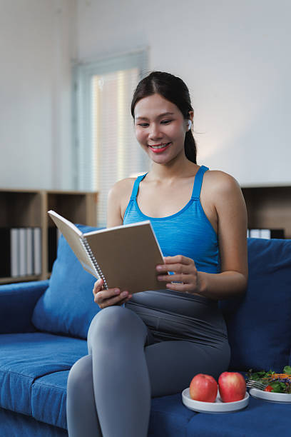 Fit woman reading meal plan | Holistic Menus