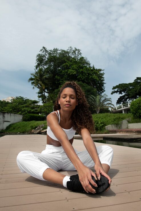 Woman meditating in white | Holistic Menus